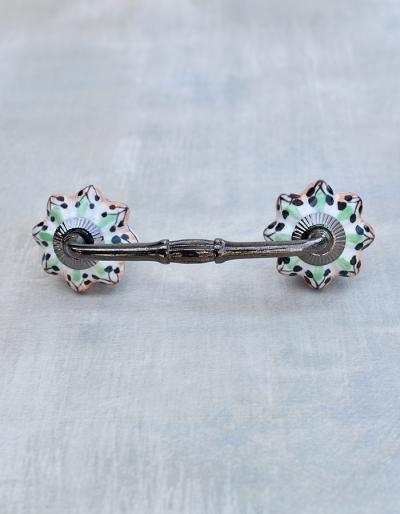 Green, black, orange colored on white ceramic Pull