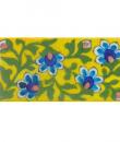 Four turqouise flower and green leaves with yellow tile