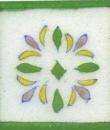 white tile with green border and green pink flower